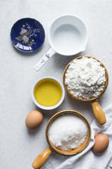 Overhead view of mise en place of ingredients for making a vanilla cake, flatlay of ingredients for making vanilla pound cake, process of making cake