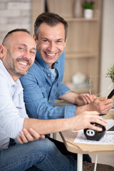Fototapeta premium happy gay couple working together in office