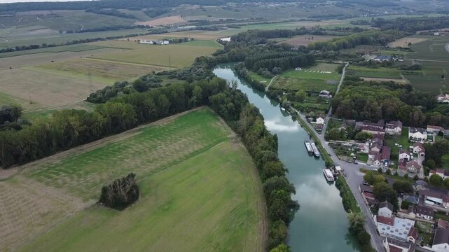 Aerial video, panoramic view of rows of green vineyards on slopes of Champagne region during grape harvest, champagne sparkling wine making in France along Marne River, premier and grand cru vineyards