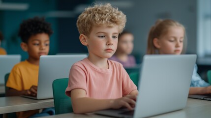 Focused children learning with laptops in a classroom setting.