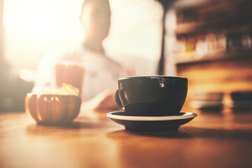 Restaurant, table and coffee of customer in cup for morning caffeine, hot beverage and service at cafe. Lens flare, cappuccino and hospitality at bistro for lunch break, energy or person at cafeteria