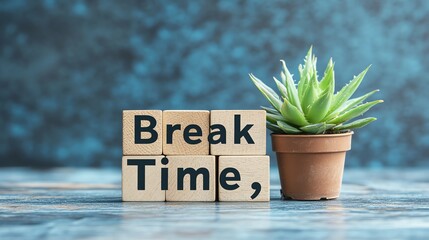Wooden blocks spelling "Break Time" with a succulent next to them on a wood table.