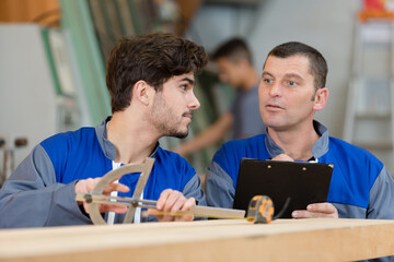 trainee carpenter using a protractor tool