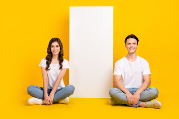 Full length photo of cute charming couple wear white t-shirts texting modern gadget empty space isolated yellow color background