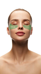 Young woman with clear, spotless skin applying under eye refreshing patches isolated on white background. Pampering morning. Concept of natural female beauty, skin care, cosmetics and cosmetology