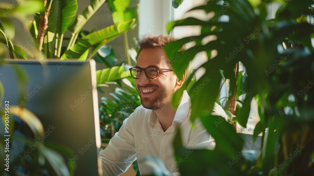 Poster a man is sitting in front of a computer monitor with a smile on his face