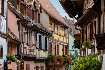 Naklejka premium Old half-timbered houses in the historic medieval old town of Eguisheim in Alsace and on Alsace Wine Route, Haut-Rhin, Grand Est, France, Europe