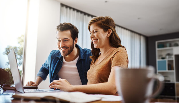 Finance, couple and paperwork with laptop in home for mortgage investment, budget savings and planning. People, technology and smile at dining table for good credit score and loan application success