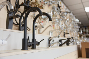 Luxury modern black chrome water tap on plumbing store display