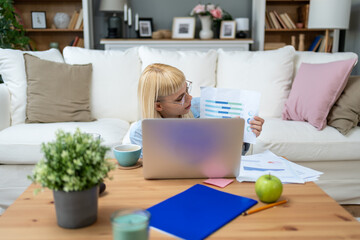Young senior university student woman of economy and finance working freelance online education job...