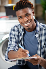 technician clipboard writing and smiling