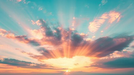 Fototapeta premium Colorful clouds illuminate the horizon as the sun sets, creating a breathtaking view in the evening sky
