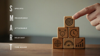 SMART business goals, SMART Goals Concept with Wooden Blocks: Specific, Measurable, Attainable, Relevant, Time-bound