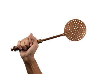 Male hand holding a vintage brass kitchen skimmer isolated no background cutout