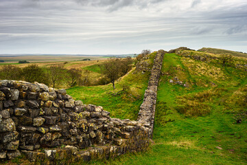 Hadrian's Wall undulates over hills at Walltown, which is a World Heritage Site in the beautiful Northumberland National Park. Popular with walkers along the Hadrian's Wall Path and Pennine Way