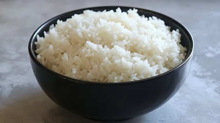 A serving of fluffy boiled rice is presented, showcasing its soft, tender grains that are perfectly cooked to a light and airy texture.