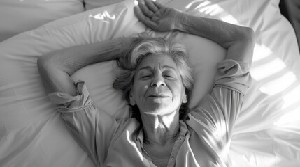 A person lying down with arms outstretched on a made bed, possibly resting or sleepy.