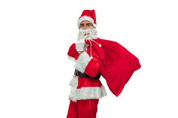 Santa Claus seen from the side holding a sack of gifts while looking at the camera white background