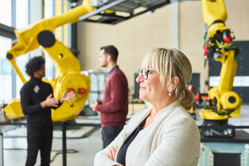 Professionals discussing robotics programming and automation in an industrial setting