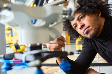 Engineer inspecting gripper arm of a robot in a modern robotics lab