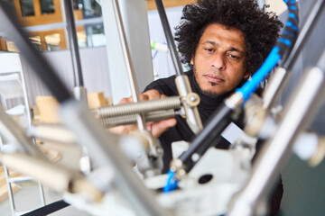Engineer programming a robotic gripper arm for industrial automation in a modern laboratory