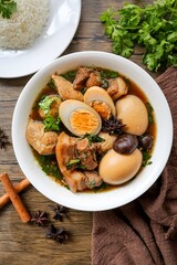 Seasoned eggs, hard boiled eggs with pork belly and white rice in Chinese Five Spices Sauce,Five Spice Egg with pork, thai called kai pa lo, boiled eggs and pork in brown soup
