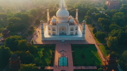 Aerial view of the majestic Taj Mahal enveloped by vibrant gardens, showcasing the elegance of this architectural wonder