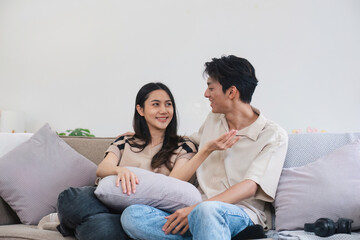 Happy Couple Relaxing on Couch in Modern Home, Enjoying Quality Time Together in Comfortable Living Room Setting