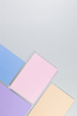 Top view of pink, purple, blue and beige notebooks on grey background. School, office wallpaper. Flat lay, copy space.	