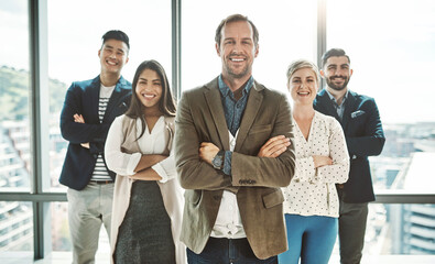 Fototapeta premium Portrait, window and business people in office with crossed arms, company pride and leader. Professional, diversity and men and women in modern workplace for teamwork, collaboration and networking