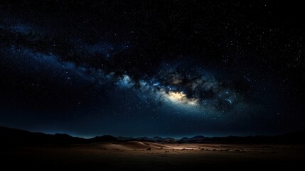 Fototapeta premium The Milky Way Galaxy casts a mesmerizing star-filled night sky over rolling sand dunes in the desert, creating a breathtaking view of the cosmos and vastness of space.