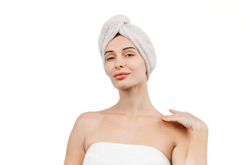 A portrait of a young woman with blue eyes wrapped in a towel after washing her hair. This image captures the essence of spa treatments, self-care, and deep relaxation.