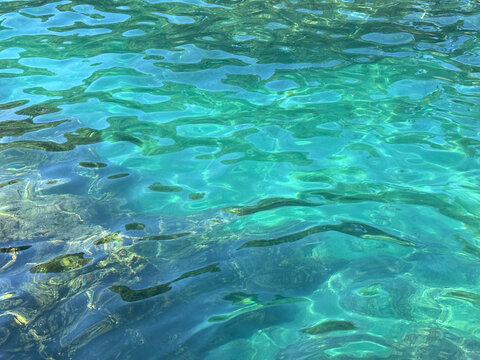 Ocean glittering clear turquoise blue water in paradise lagoon.