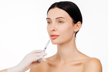 A doctor's hands holding a syringe near a woman's face as she receives a skin lifting injection. This moment emphasizes beauty and modern skincare techniques for a radiant appearance.