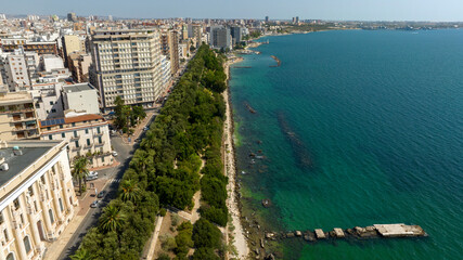 Fototapeta premium Aerial view of the seafront located in Taranto, Puglia, Italy. It is a beautiful tree-lined promenade.
