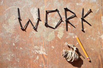 word work made of screws and yellow pencil with handmade leveling device