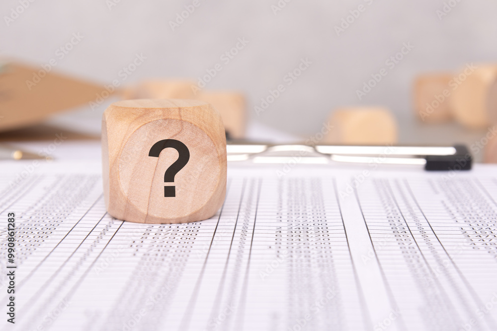 Poster a question mark on financial documents signals the need for scrutiny and highlights issues