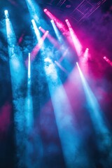Colorful Stage Lights with Blue and Pink Beams Shining Through Smoke at a Concert or Event