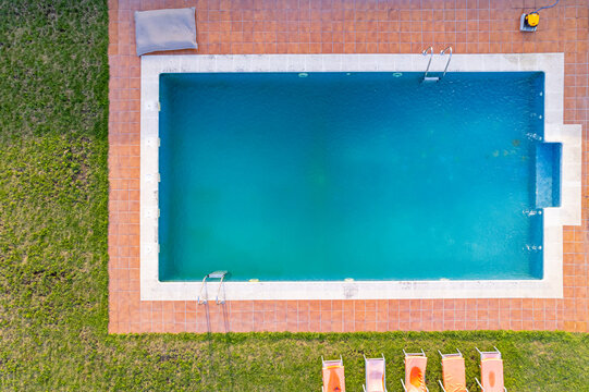 Aerial view image from a drone of a swimming pool in a summer day