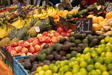 The Hague, Netherlands - July 9, 2004: Close-up of apples surrounded by other types of fruit such as pineapples, bananas, avocados and lemons. Haagse Market in The Hague, Netherlands.