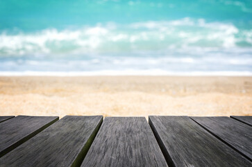 Empty wooden table with blurred beach background