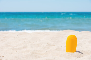 Sunscreen bottle on the beach