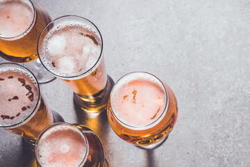 Beer glasses on gray stone background