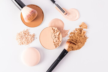 A beautiful cosmetic background with various types of compact powder, strokes of liquid powder and...