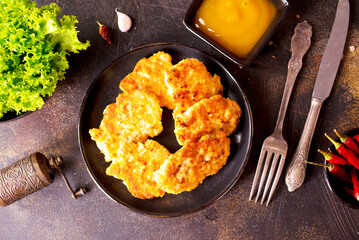 white fish cutlets on black plate