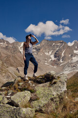 Girl in the mountains enjoying the view looking up trekking hiking