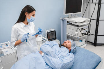 Obraz premium Endoscopy at the hospital. Doctor gastroenterologist holding endoscope before gastroscopy in a modern medical private clinic cabinet hospital . Medical examination