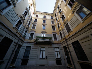 Old residential building along via Biondi in Milan, Italy