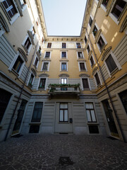 Old residential building along via Biondi in Milan, Italy