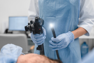 Gastrointestinal fiberoptic endoscopy concept. Cropped close up shot of female doctor holding...